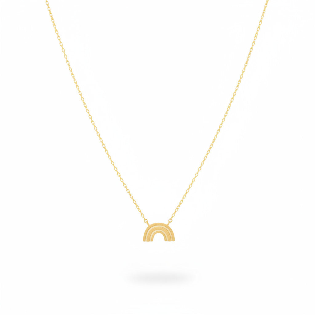 Gold necklace with a small rainbow pendant on a white background