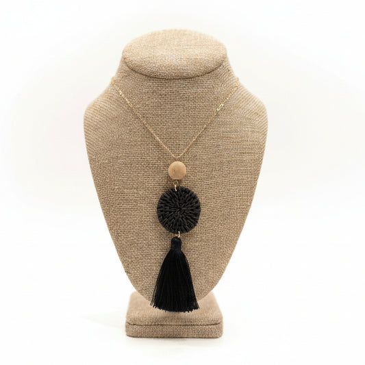 Necklace with tassel on a beige bust