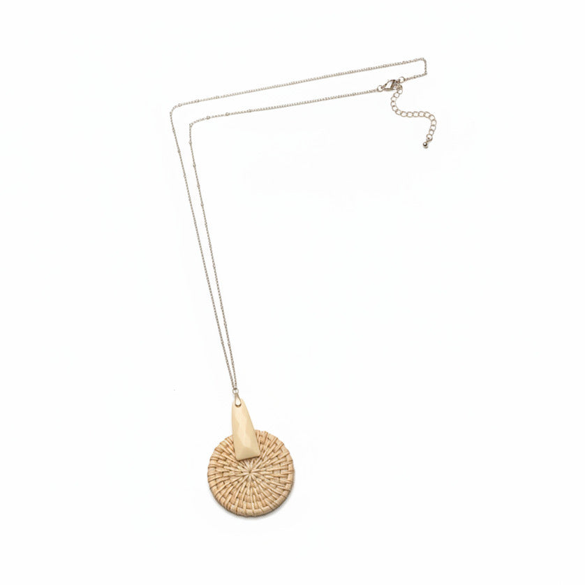 Long necklace with woven pendant on a white background.