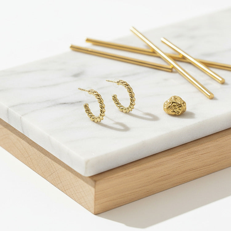gold mini hoop textured earrings with marble riser