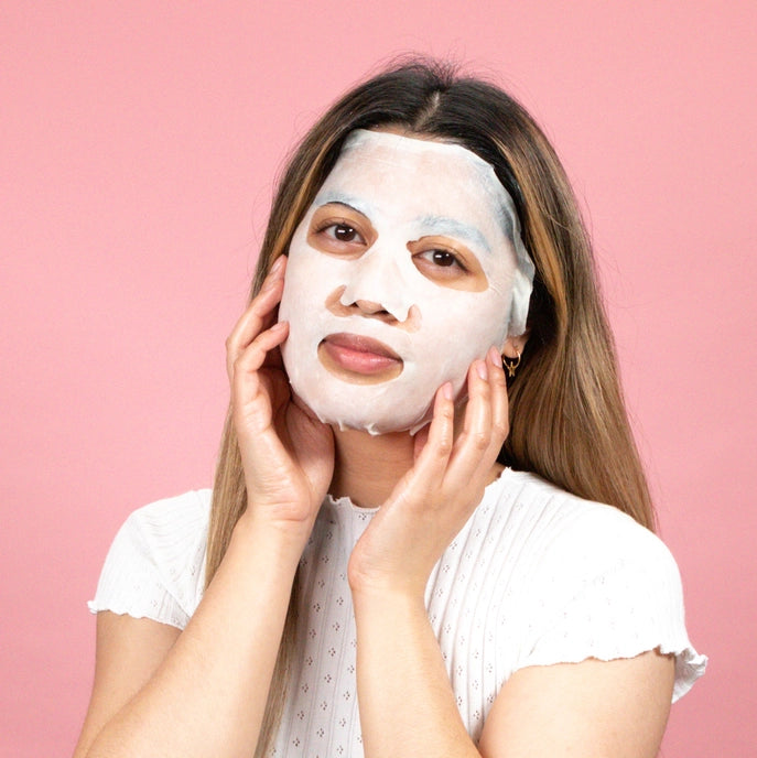 Photo of woman with sheet mask on.