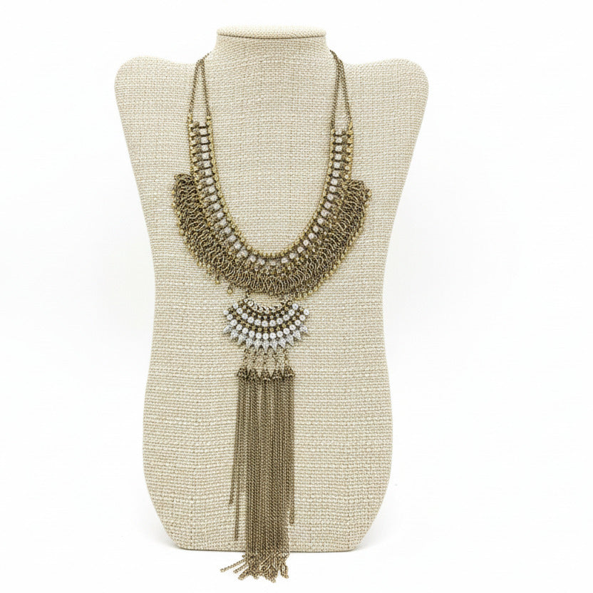 Antique Gold Statement Necklace on a beige neckform with a white background
