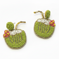 Beaded earrings shaped like coconuts on a wooden surface