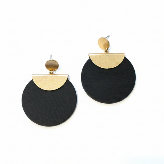 Black and gold earrings on a white surface