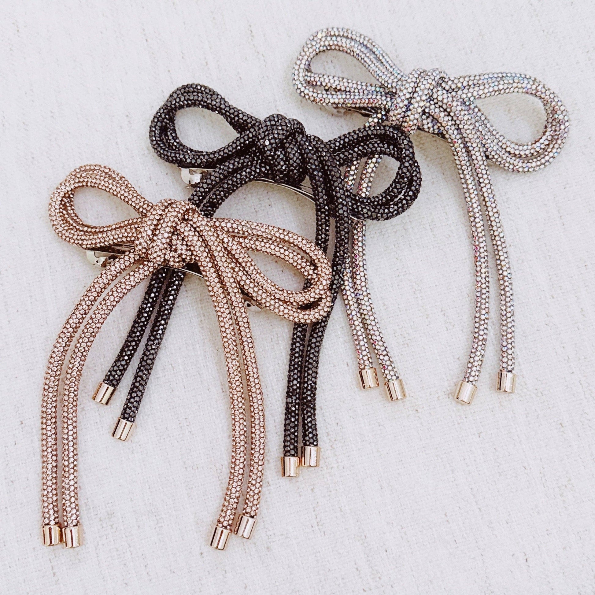 Set of metallic laces in gold, silver, and bronze on a light background