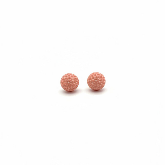Pair of pink textured round earrings on a white background