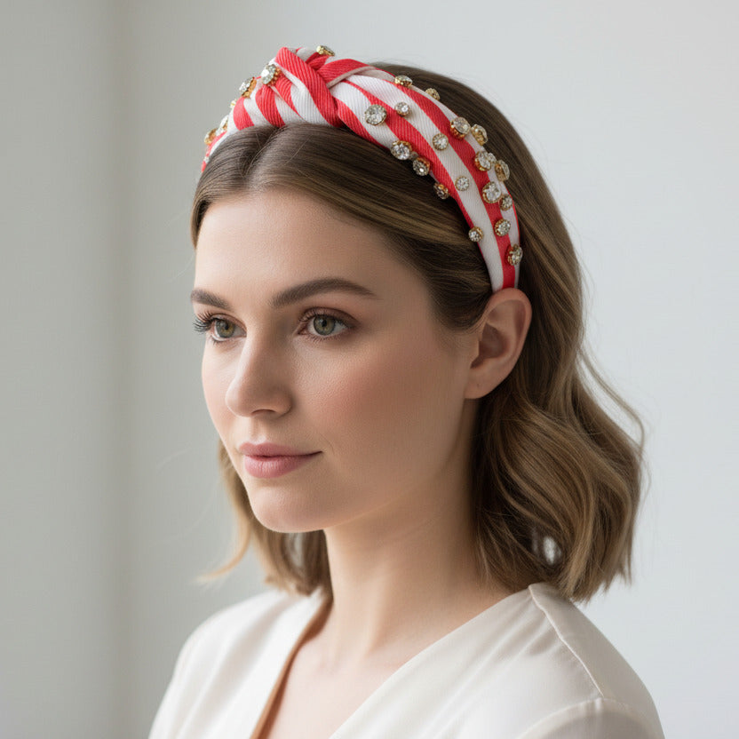 Orange and white striped headband with rhinestone elements on a woman's head