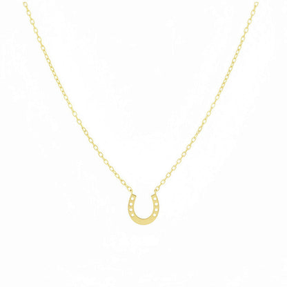 Gold necklace with horseshoe pendant on a white background