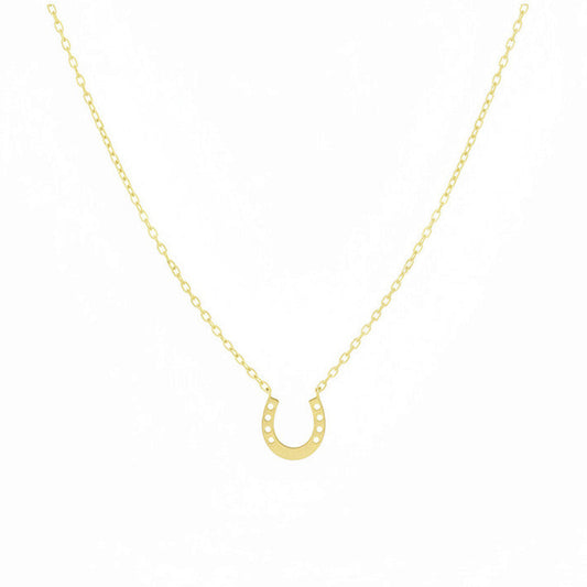 Gold necklace with horseshoe pendant on a white background