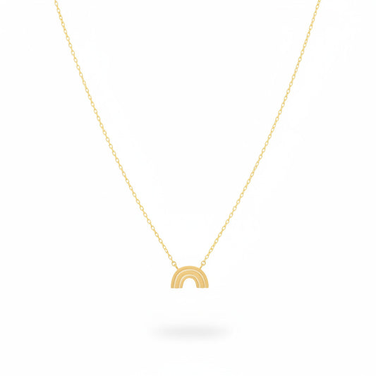 Gold necklace with a small rainbow pendant on a white background