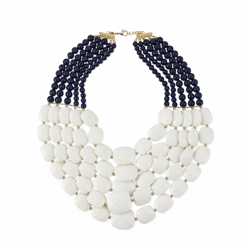 Necklace with white beads and navy blue beaded strands on a white background
