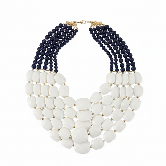 Necklace with white beads and navy blue beaded strands on a white background