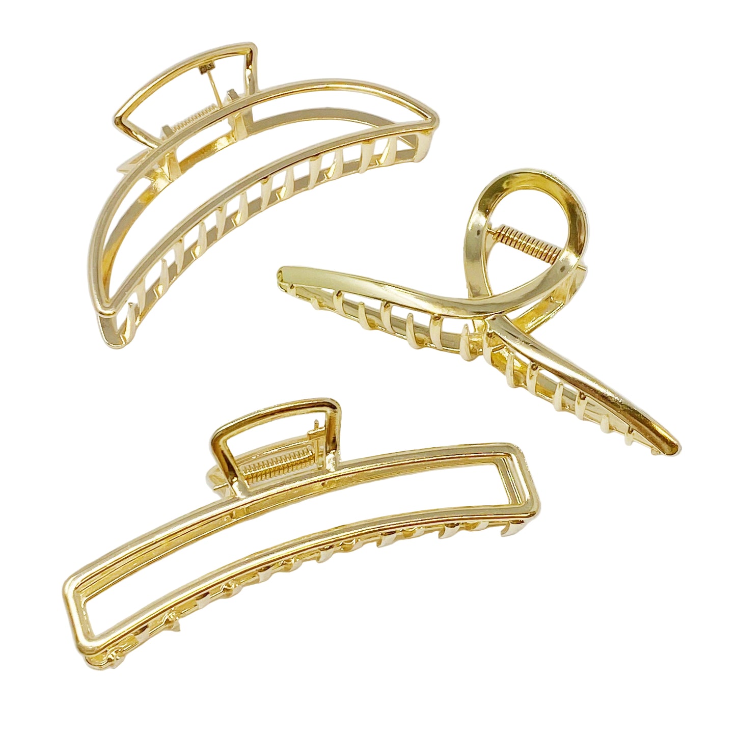 Three gold hair clips on a white background