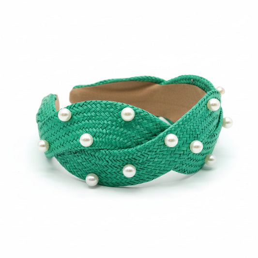 Green headband with pearls on a white surface