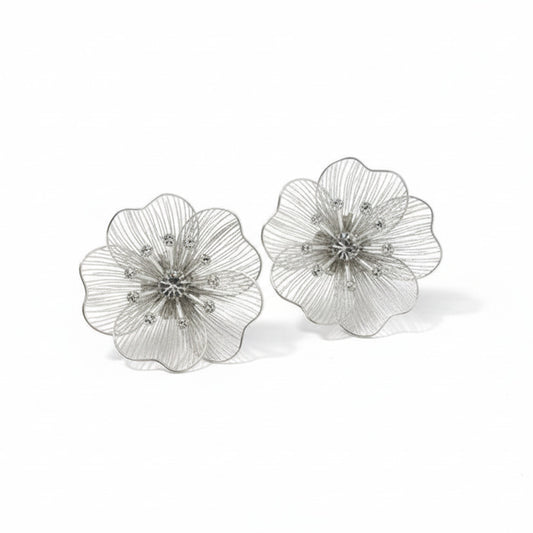 Silver floral earrings on a  white background