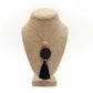 Necklace with tassel on a beige bust