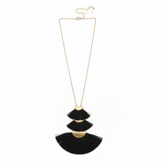Necklace with black tassel pendants on a white surface