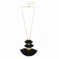 Necklace with black tassel pendants on a white surface