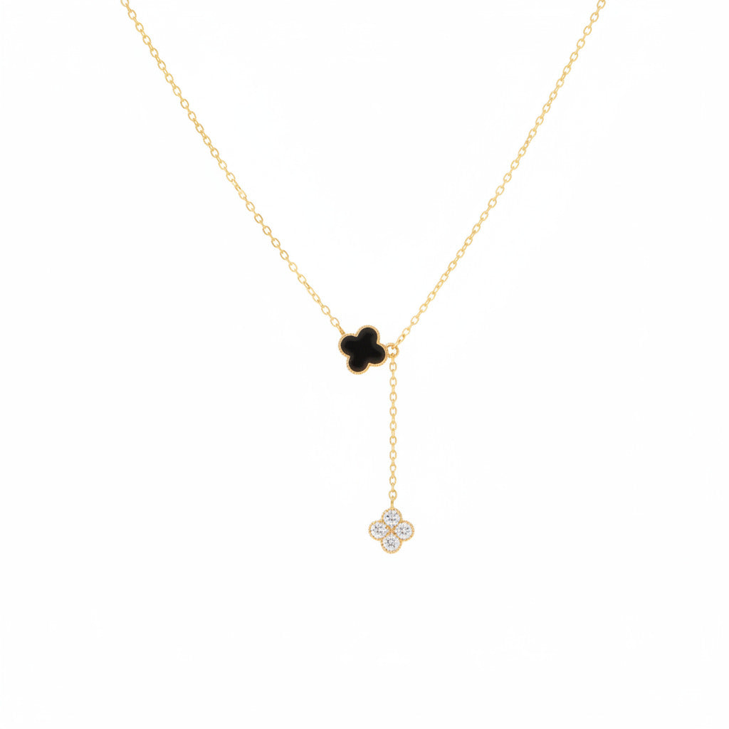 Gold necklace with a clover-shaped pendant on a white background.
