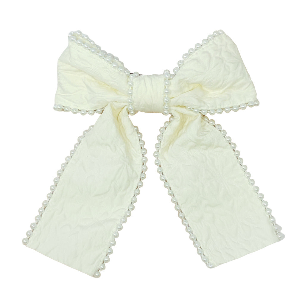 Large bow with pearl details on  white background