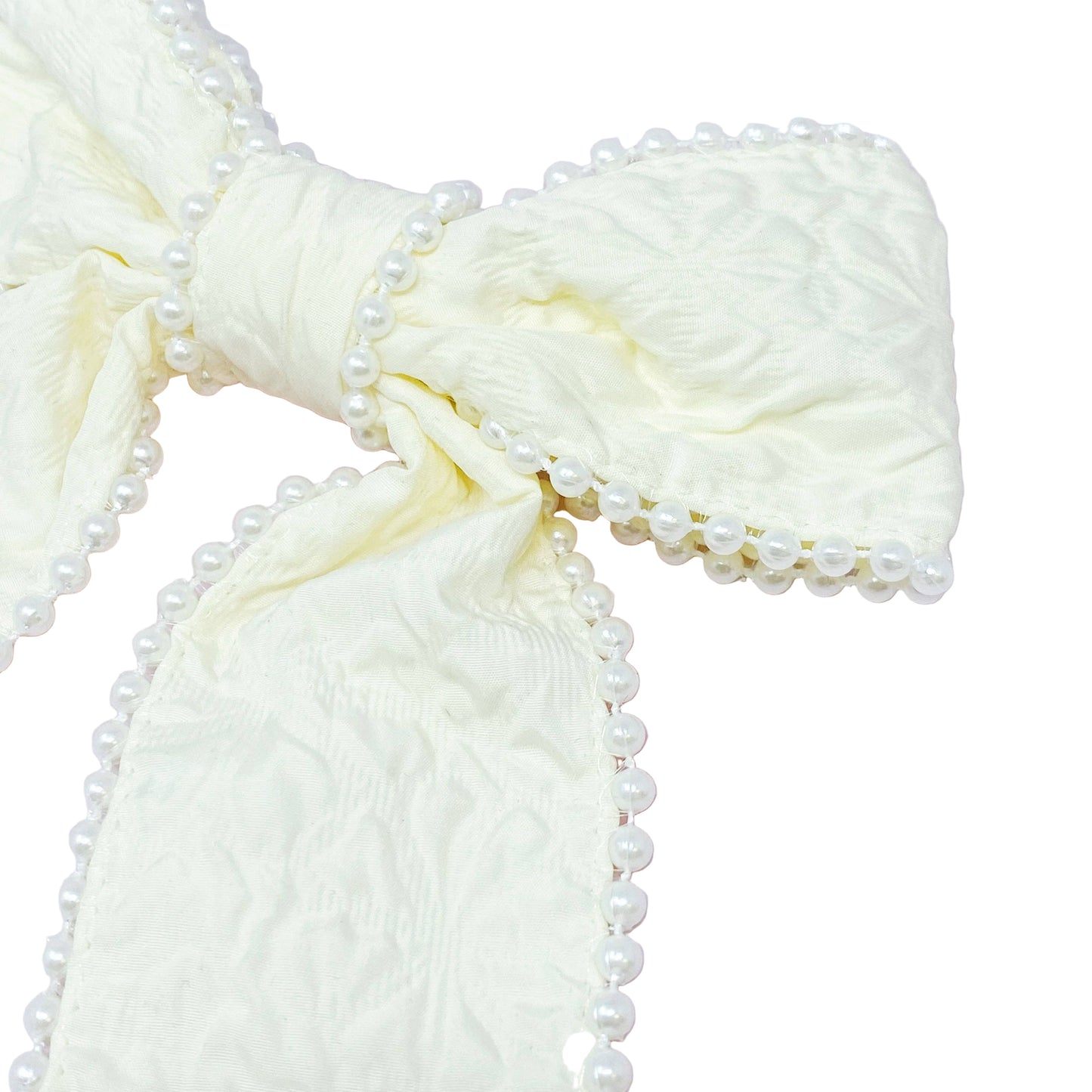 Cream-colored fabric with pearl trim on a white background