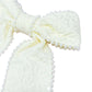 Cream-colored fabric with pearl trim on a white background