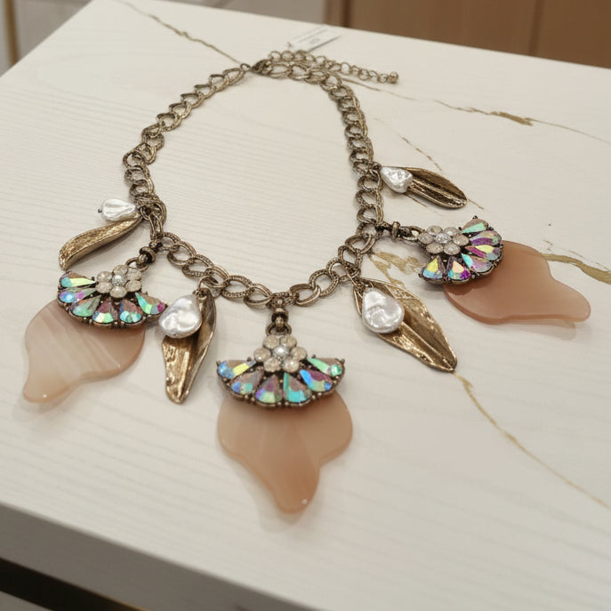Necklace with various charms on a textured surface