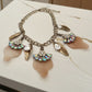 Necklace with various charms on a textured surface