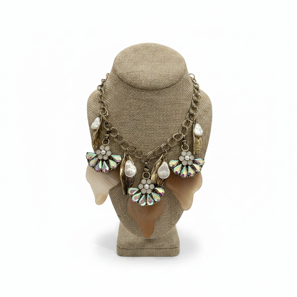Necklace with floral and pearl details on a mannequin head against a white background