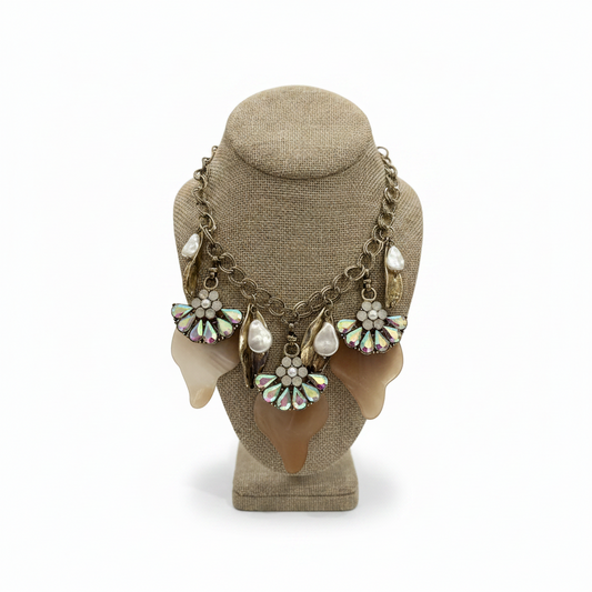 Necklace with floral and pearl details on a mannequin head against a white background