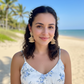 Woman on a beach with dangle raffia earrings