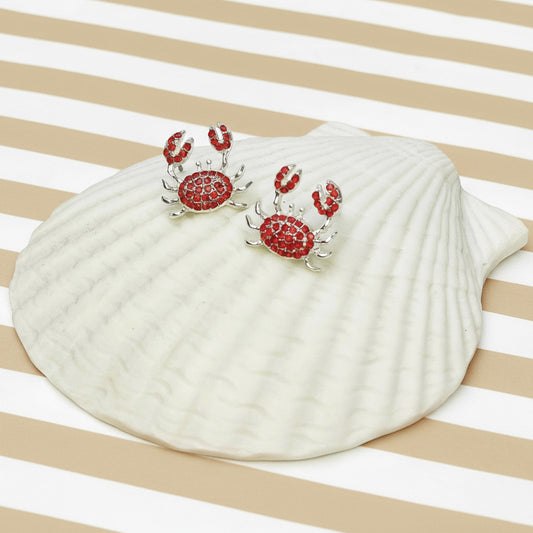 Seashell with red crab design on a striped background