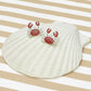 Seashell with red crab design on a striped background
