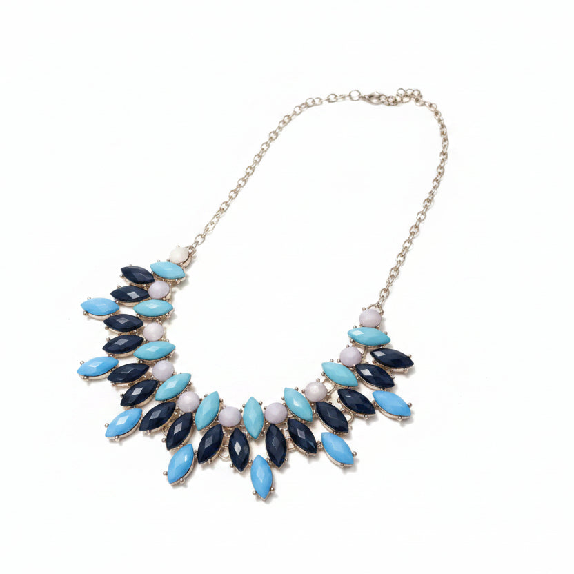 Necklace with blue and navy beads on a white surface