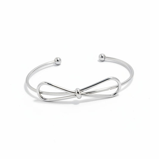 Silver bow-shaped bracelet on a white background