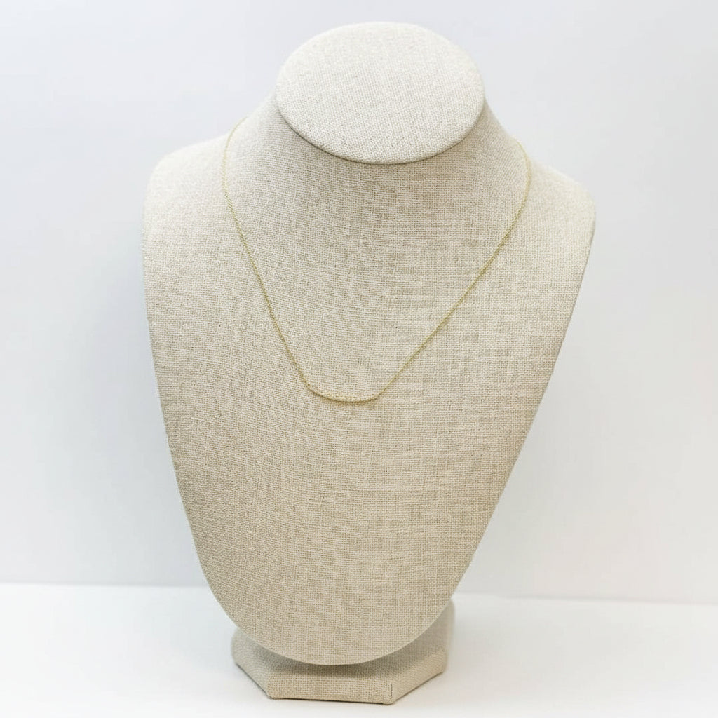 Gold necklace with pave rhinestones on a neutral bust