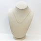 Gold necklace with pave rhinestones on a neutral bust