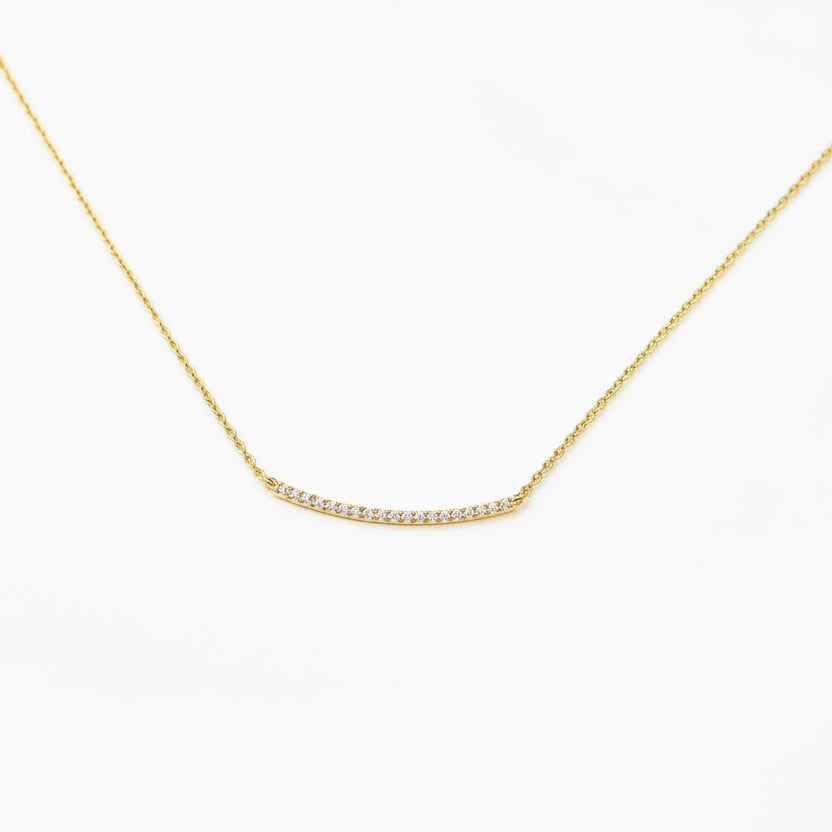gold necklace with pave rhinestones on a white background