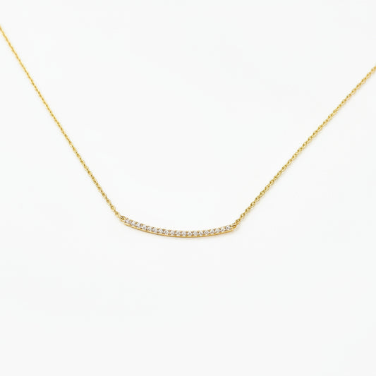 gold necklace with pave rhinestones on a white background