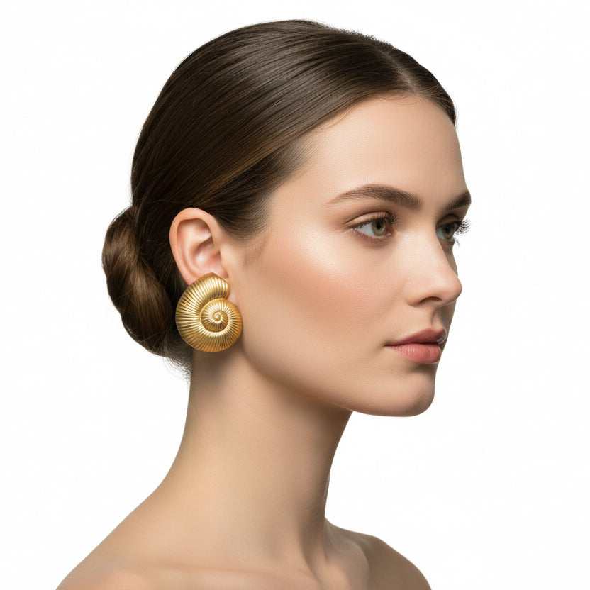 Gold earring on a female head against a white background