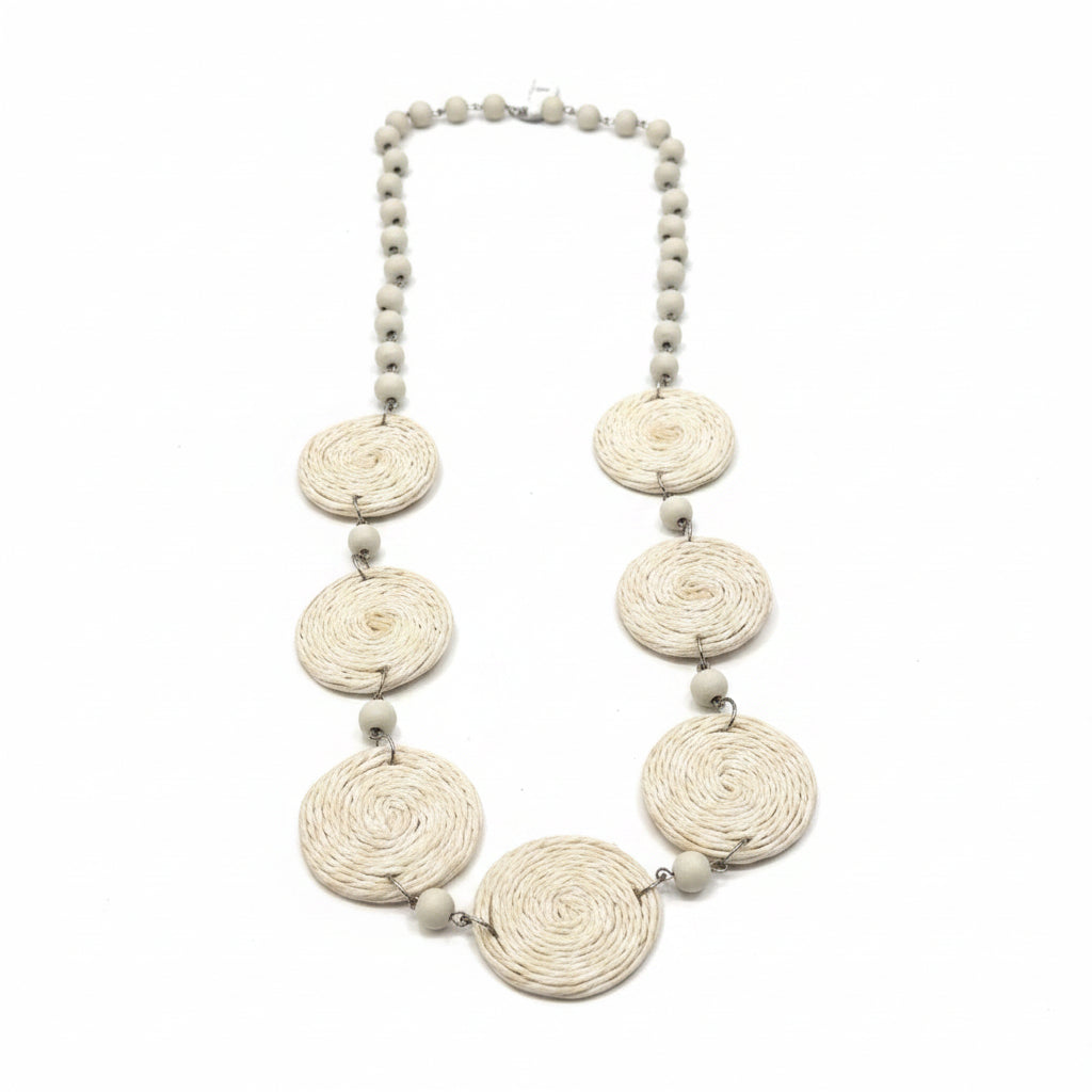Necklace with decorative elements on a white surface