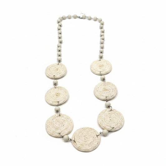 Necklace with decorative elements on a white surface