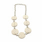 Necklace with decorative elements on a white surface
