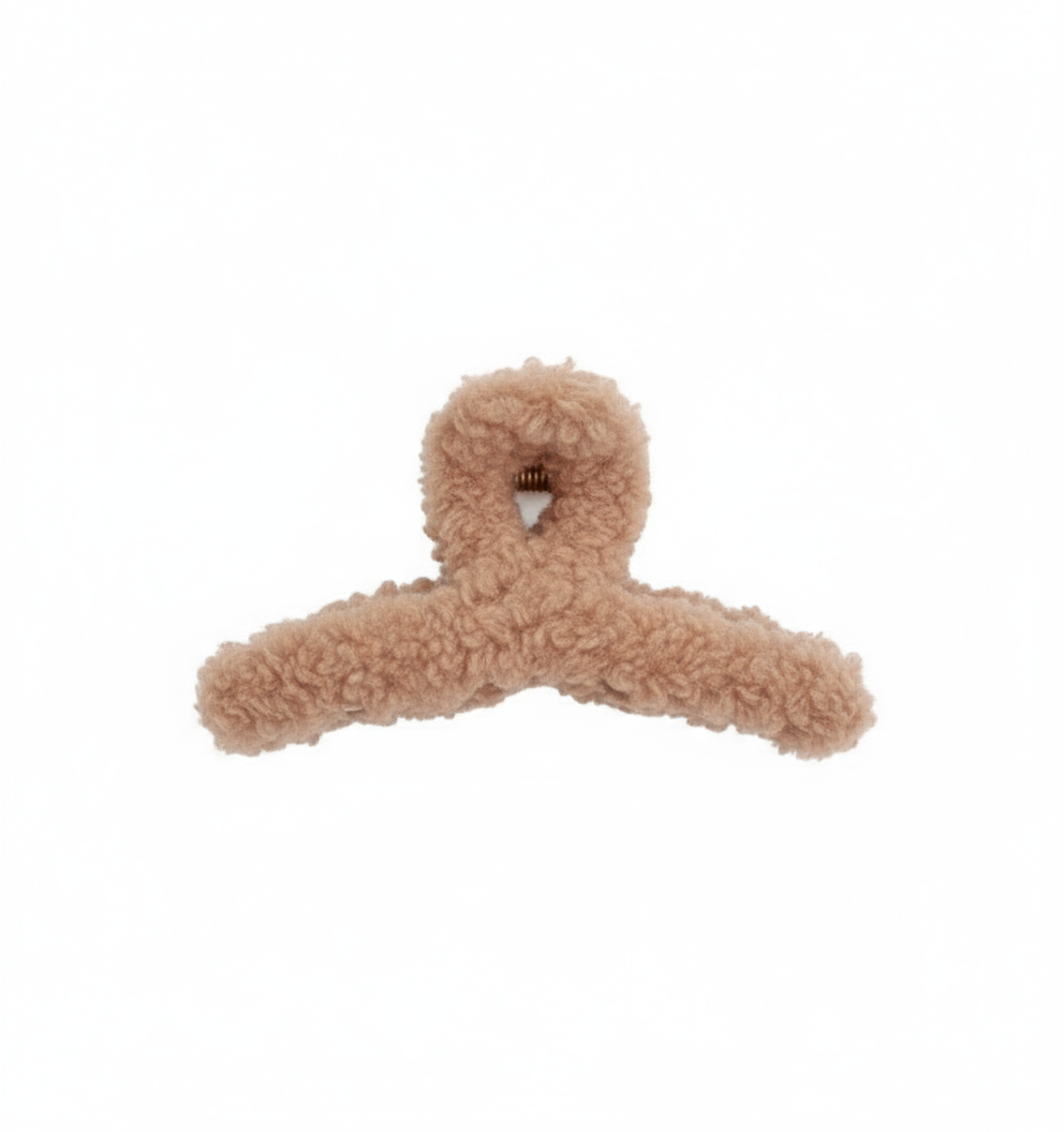 fuzzy tan hair clip on a white background