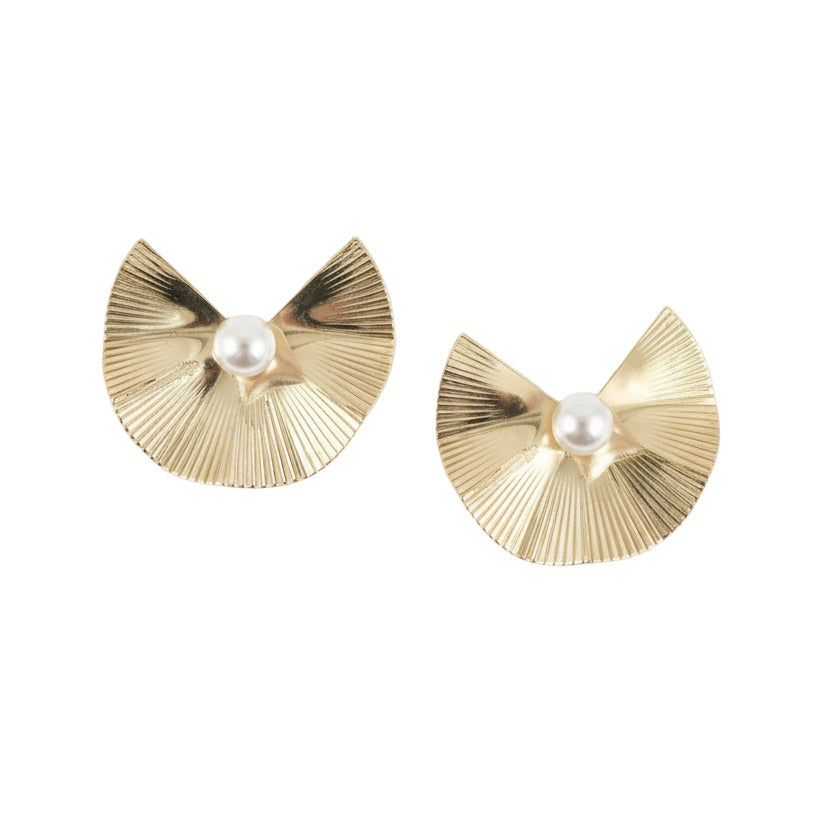 Gold earrings with pearl centers on a white background