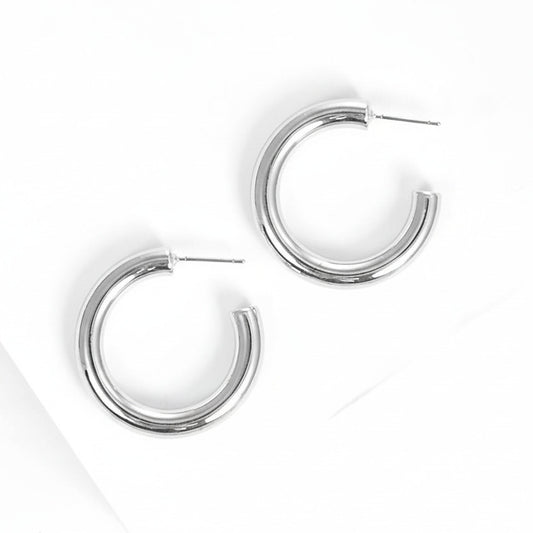 Silver hoop earrings on white background