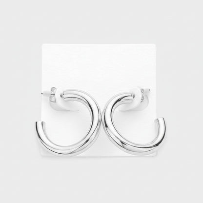 Silver earrings on a white card