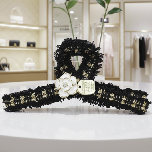 tweed and flower claw clip in a boutique