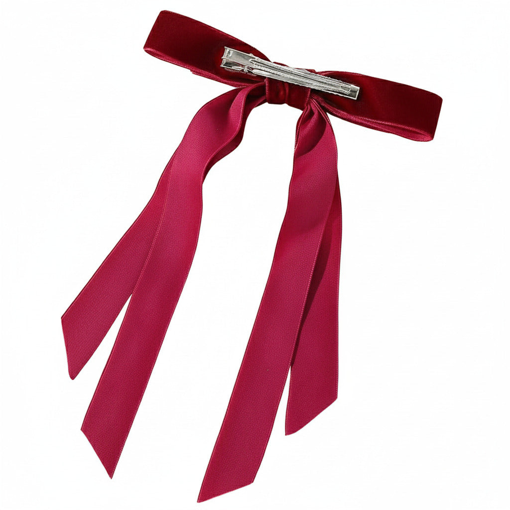 Red ribbon hair clip on a white background
