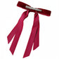 Red ribbon hair clip on a white background